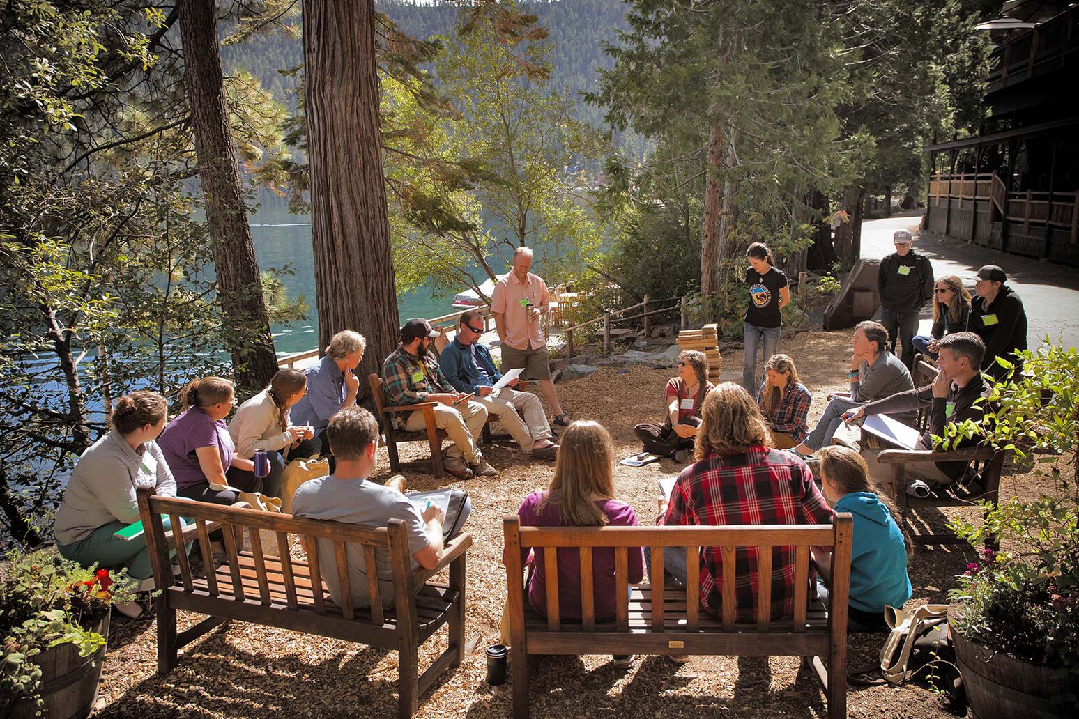 Who We Support - Community gathering in forest setting